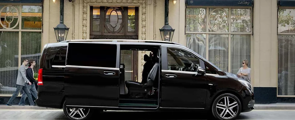 a car standing on road with open back doors