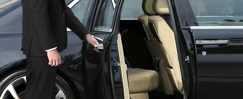 Man opening the back door of a car