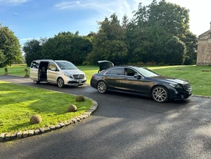 two cars standing with open gates