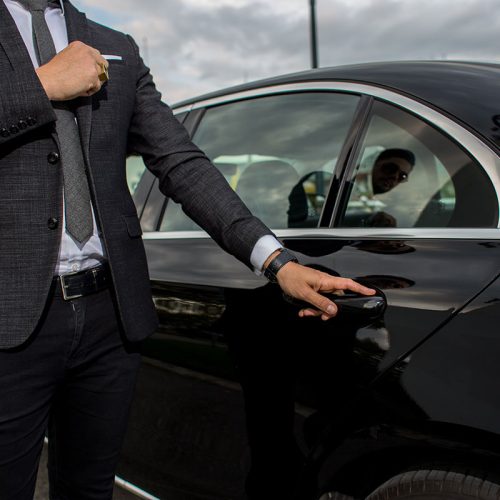 man holding car door handle